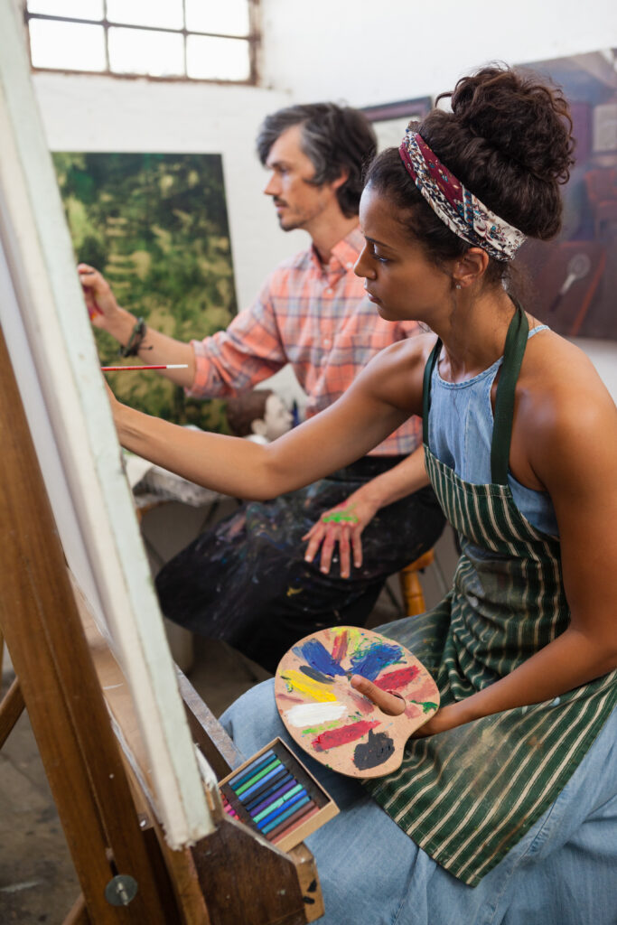 Man and woman painting on canvas man and woman painting on canvas